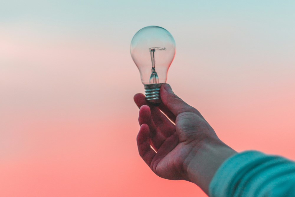 A light bulb held in a hand